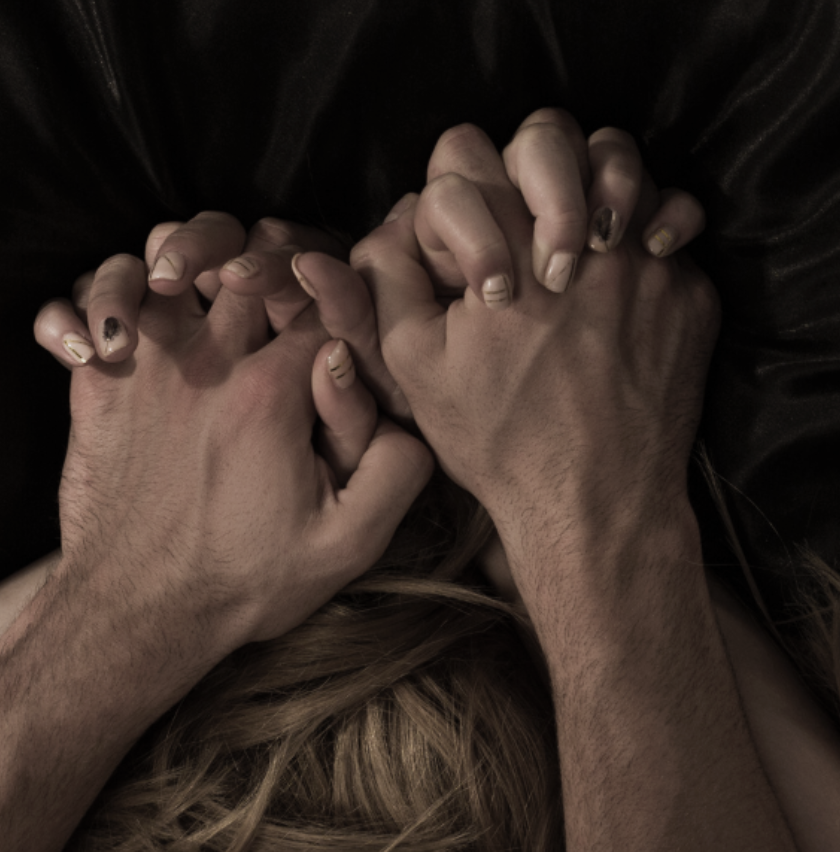 Warming : Close up of couple’s hands clenched intimately