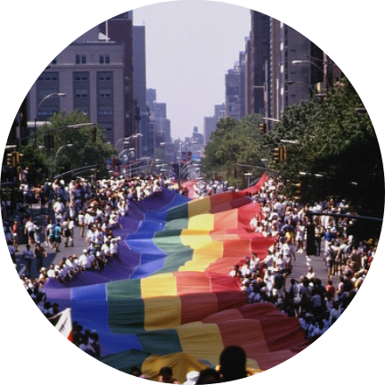 1979 Pride parade and large flag held by crowds of people