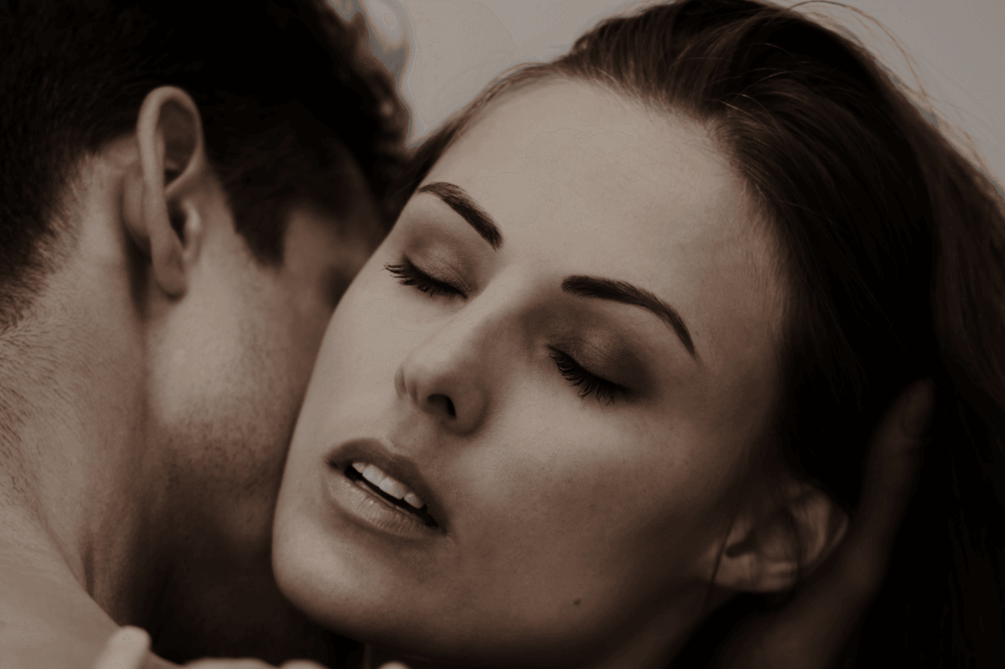 Couple kissing and using lube to spice up their sex life